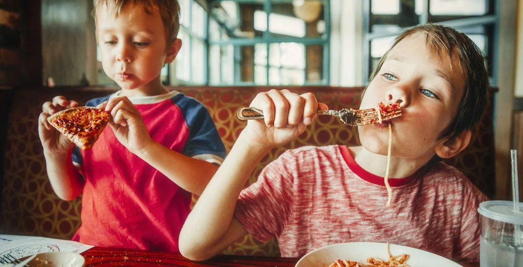 Kids eating pizza and pasta